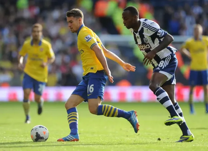 Framed Print : Arsenal's Aaron Ramsey Faces Off Against Saido Berahino in Premier League Clash (West Bromwich Albion vs Arsenal, 2013-14) Framed Print : Arsenal's Aaron Ramsey Faces Off Against Saido Berahino in Premier League Clash (West Bromwich Albion vs Arsenal, 2013-14)