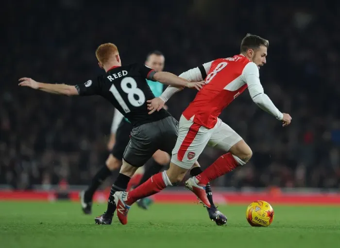 Framed Print : Arsenal's Aaron Ramsey Faces Off Against Southampton's Harrison Reed in EFL Cup Clash
