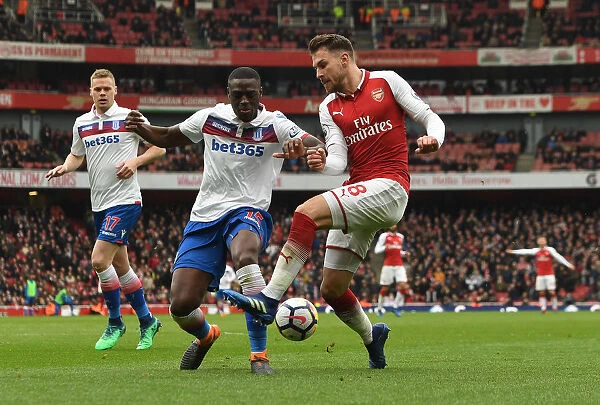 Arsenal's Aaron Ramsey Faces Off Against Stoke's Bruno Martins Indi in Intense Premier League Clash