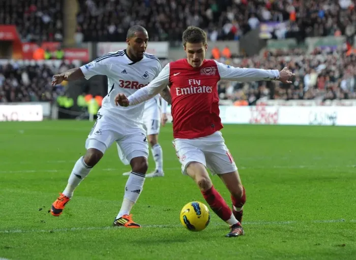 Framed Print : Arsenal's Aaron Ramsey Faces Off Against Swansea City's Kemy Agustien (2011-12)
