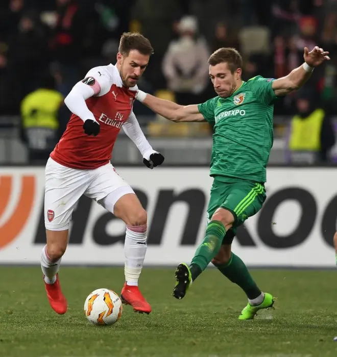 Framed Print : Arsenal's Aaron Ramsey Faces Off Against Vorskla's Lurii Kolomoets in Europa League Clash Framed Print : Arsenal's Aaron Ramsey Faces Off Against Vorskla's Lurii Kolomoets in Europa League Clash