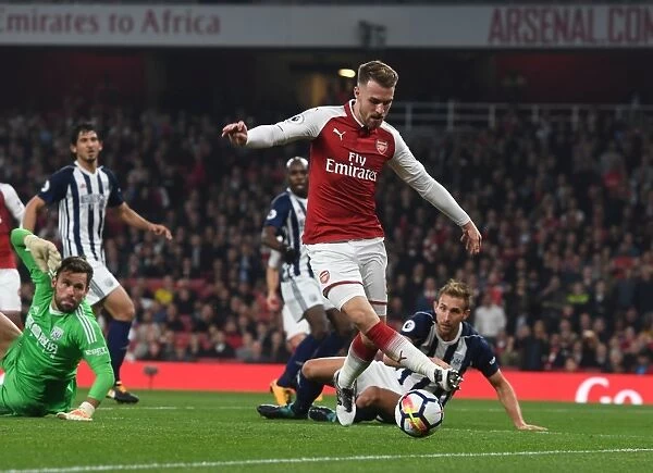 Arsenal's Aaron Ramsey Faces Off Against West Bromwich Albion's Ben Foster