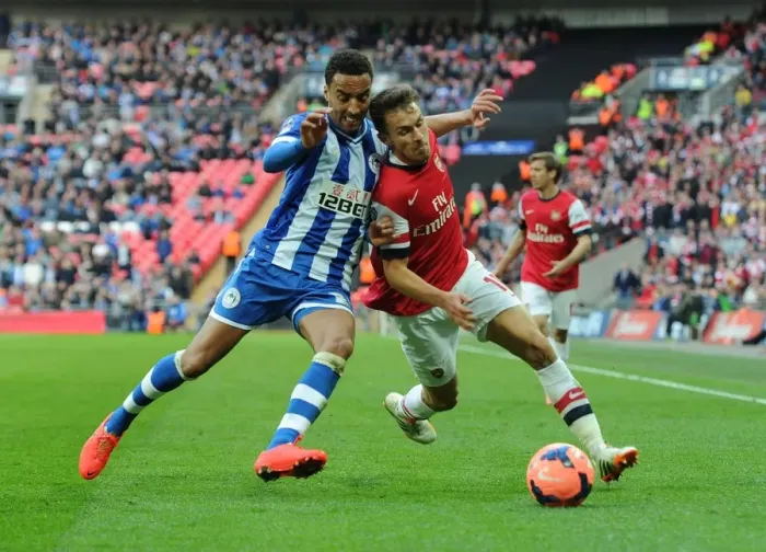 Framed Print : Arsenal's Aaron Ramsey Faces Off Against Wigan's James Perch in FA Cup Semi-Final Showdown Framed Print : Arsenal's Aaron Ramsey Faces Off Against Wigan's James Perch in FA Cup Semi-Final Showdown