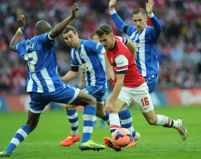 Framed Print : Arsenal's Aaron Ramsey Faces Off Against Wigan's McArthur, Boyce, and Collison in FA Cup Semi-Final Showdown