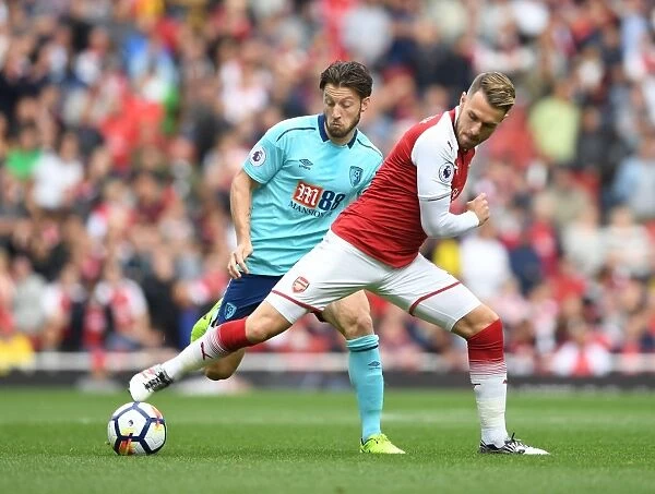 Arsenal's Aaron Ramsey Fends Off Harry Arter in Intense Arsenal v AFC Bournemouth Clash (2017-18)