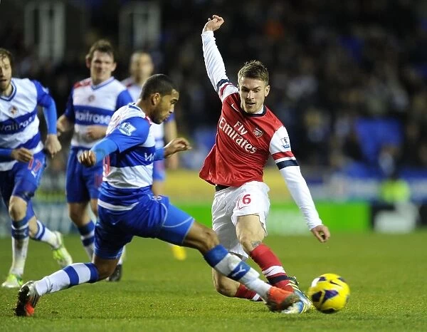 Arsenal's Aaron Ramsey Fends Off Reading's Adrian Mariappa