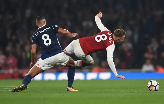 Framed Print : Arsenal's Aaron Ramsey Fouled by Jake Livermore in 2017-18 Premier League Clash Framed Print : Arsenal's Aaron Ramsey Fouled by Jake Livermore in 2017-18 Premier League Clash
