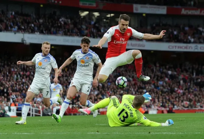 Framed Print : Arsenal's Aaron Ramsey Leaps Over Sunderland's Jordan Pickford