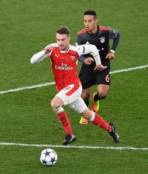Arsenal's Aaron Ramsey Outmaneuvers Bayern's Thiago in Champions League Showdown