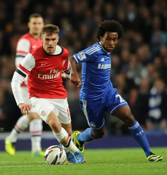 Framed Print : Arsenal's Aaron Ramsey Outmaneuvers Chelsea's William in Capital One Cup Showdown Framed Print : Arsenal's Aaron Ramsey Outmaneuvers Chelsea's William in Capital One Cup Showdown