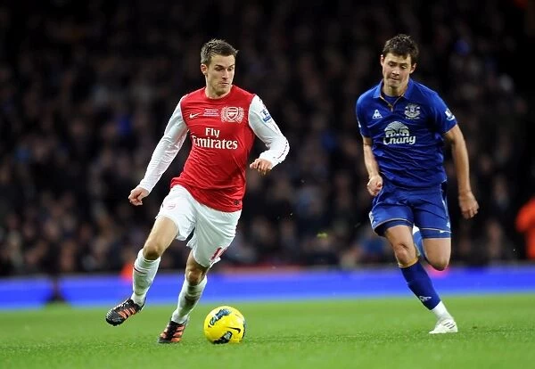 Arsenal's Aaron Ramsey Outmaneuvers Everton's Diniyar Bilyaletdinov
