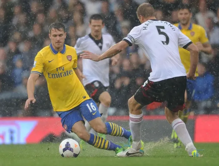 Framed Print : Arsenal's Aaron Ramsey Outmaneuvers Fulham's Brede Hangeland in Premier League Clash