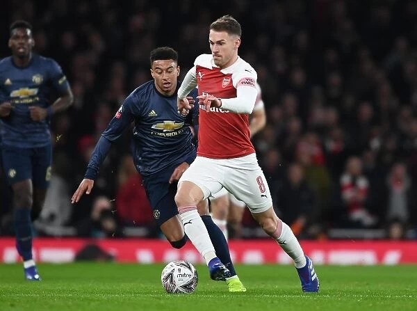 Arsenal's Aaron Ramsey Outmaneuvers Manchester United's Jesse Lingard in FA Cup Clash