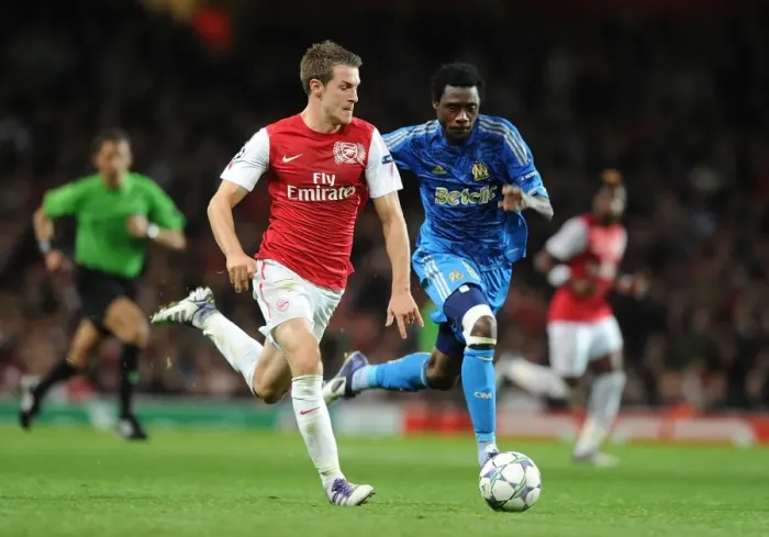 Framed Print : Arsenal's Aaron Ramsey Outmaneuvers Marseille's Koulouté in 2011-12 Champions League Clash Framed Print : Arsenal's Aaron Ramsey Outmaneuvers Marseille's Koulouté in 2011-12 Champions League Clash