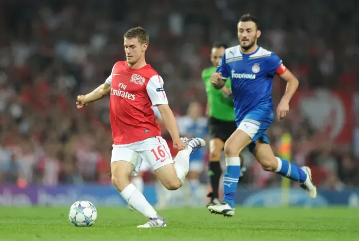 Framed Print : Arsenal's Aaron Ramsey Outmaneuvers Olympiacos Vassilis Torossidis during the 2011-12 Champions League Clash Framed Print : Arsenal's Aaron Ramsey Outmaneuvers Olympiacos Vassilis Torossidis during the 2011-12 Champions League Clash