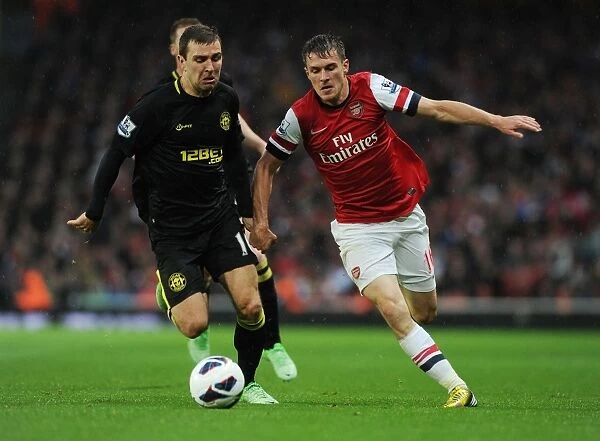 Arsenal's Aaron Ramsey Outsmarts James McArthur: The Skillful Pass at Emirates Stadium, 2013