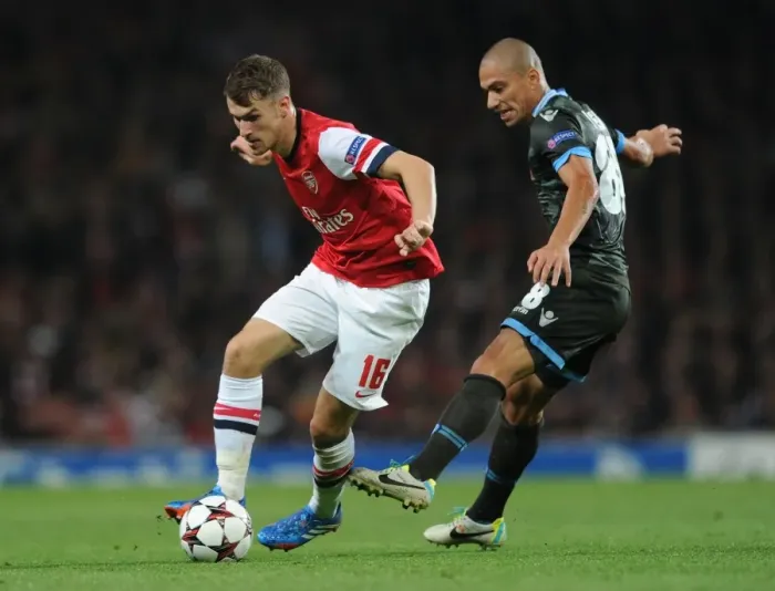 Framed Print : Arsenal's Aaron Ramsey Outwits Napoli's Gokhan Inler: A Moment of Genius in the Champions League Clash Framed Print : Arsenal's Aaron Ramsey Outwits Napoli's Gokhan Inler: A Moment of Genius in the Champions League Clash