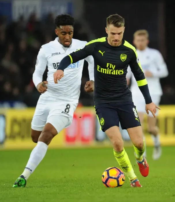 Framed Print : Arsenal's Aaron Ramsey Outwits Swansea's Leroy Fer in Thrilling Premier League Clash Framed Print : Arsenal's Aaron Ramsey Outwits Swansea's Leroy Fer in Thrilling Premier League Clash