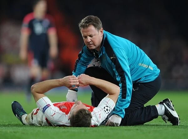 Arsenal's Aaron Ramsey Receives Medical Attention from Physio Colin Lewin during Arsenal vs. FC Bayern Munich (2015)