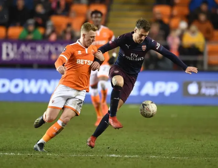 Framed Print : Arsenal's Aaron Ramsey Scores Past Blackpool's Callum Guy in FA Cup Third Round Framed Print : Arsenal's Aaron Ramsey Scores Past Blackpool's Callum Guy in FA Cup Third Round