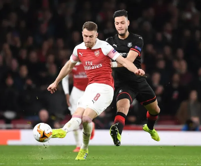 Framed Print : Arsenal's Aaron Ramsey Scores Past Rennes Ramu Bensebaini in Europa League Showdown Framed Print : Arsenal's Aaron Ramsey Scores Past Rennes Ramu Bensebaini in Europa League Showdown