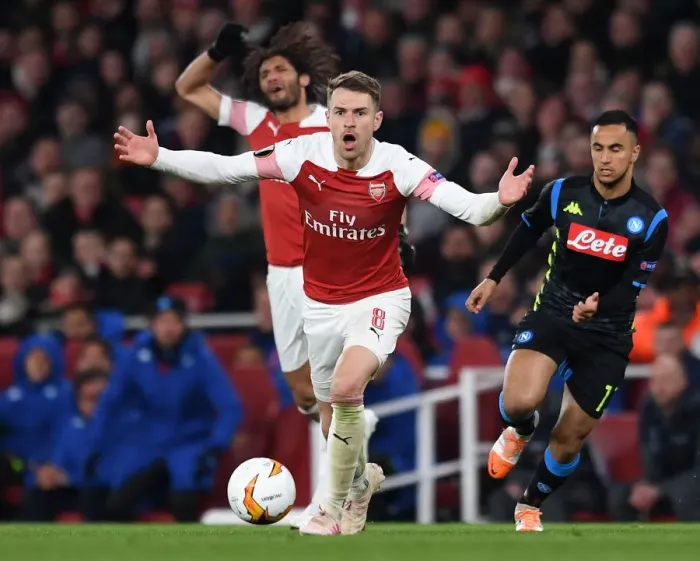 Framed Print : Arsenal's Aaron Ramsey: Unyielding Determination in Europa League Battle Against Napoli