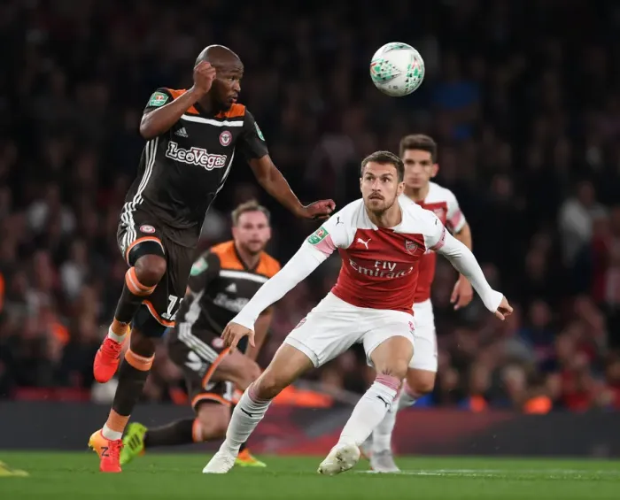 Framed Print : Arsenal's Aaron Ramsey vs. Brentford's Kamohelo Mokotjo: A Carabao Cup Showdown Framed Print : Arsenal's Aaron Ramsey vs. Brentford's Kamohelo Mokotjo: A Carabao Cup Showdown