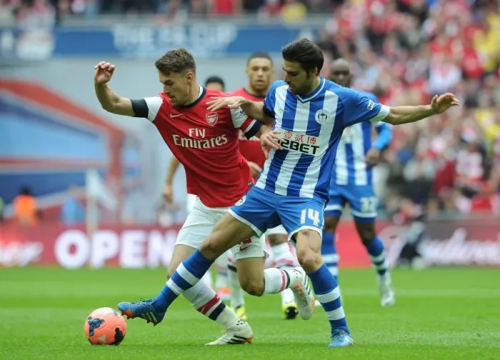 Framed Print : Arsenal's Aaron Ramsey vs. Wigan's Jordi Gomez: A FA Cup Semi-Final Battle Framed Print : Arsenal's Aaron Ramsey vs. Wigan's Jordi Gomez: A FA Cup Semi-Final Battle