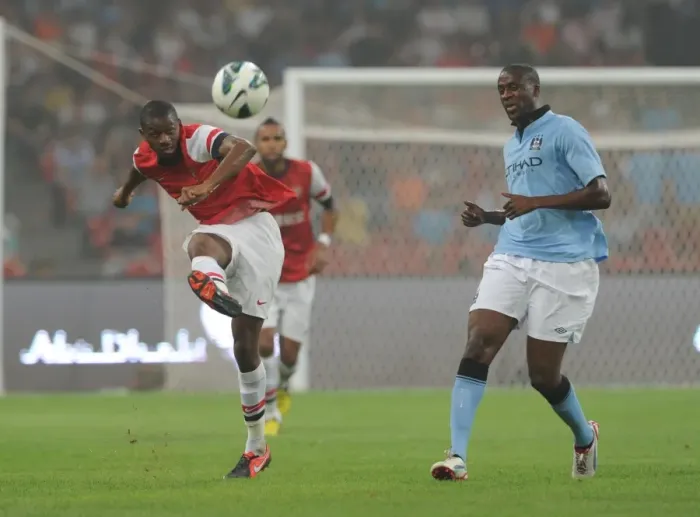 Framed Print : Arsenal's Abou Diaby Battles Past Yaya Toure in Arsenal FC vs Manchester City Pre-Season Clash in Beijing, 2012