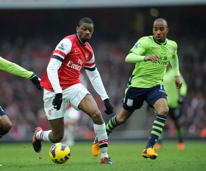 Framed Print : Arsenal's Abou Diaby Clashes with Aston Villa's Fabian Delph in Premier League Showdown