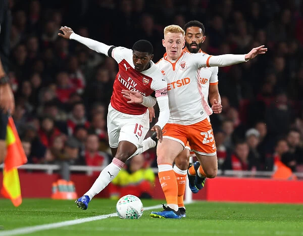 Arsenal's Ainsley Maitland-Niles Faces Off Against Blackpool's Calum Guy in Carabao Cup Clash