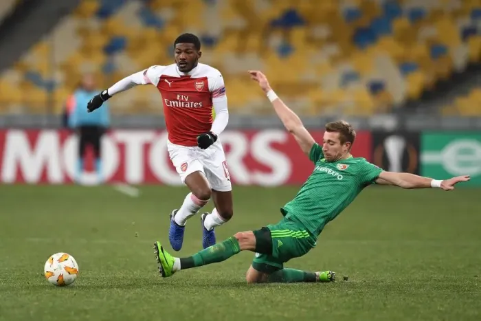 Framed Print : Arsenal's Ainsley Maitland-Niles Faces Off Against Vorskla Poltava's Lurii Kolomoets in Europa League Clash
