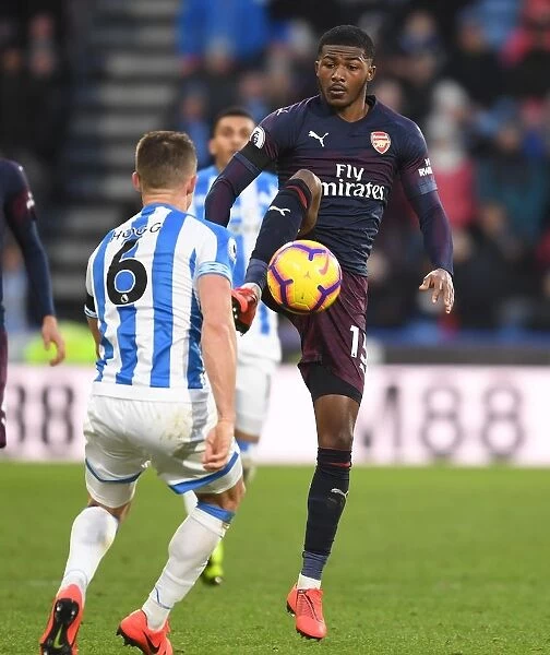 Arsenal's Ainsley Maitland-Niles Goes Head-to-Head with Huddersfield's Jonathan Hogg in Intense Premier League Clash