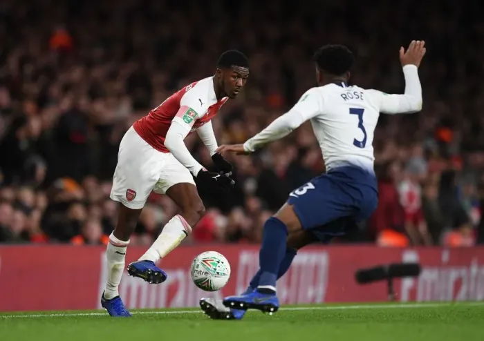 Framed Print : Arsenal's Ainsley Maitland-Niles Outmaneuvers Tottenham's Danny Rose in Carabao Cup Quarterfinal Showdown