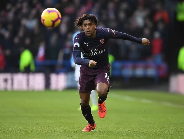 Arsenal's Alex Iwobi in Action Against Huddersfield Town in Premier League