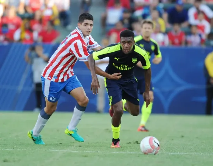 Framed Print : Arsenal's Alex Iwobi Breaks Past Chivas Orbelin Pineda in Pre-Season Clash Framed Print : Arsenal's Alex Iwobi Breaks Past Chivas Orbelin Pineda in Pre-Season Clash