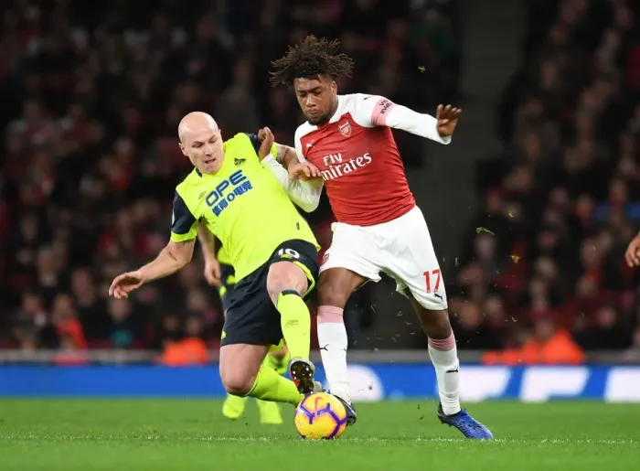 Framed Print : Arsenal's Alex Iwobi Clashes with Huddersfield's Aaron Mooy in Premier League Showdown