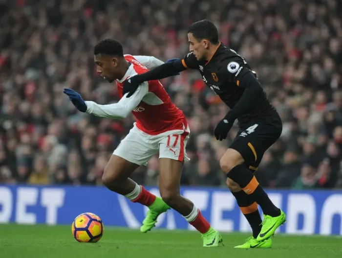 Framed Print : Arsenal's Alex Iwobi Clashes with Hull's Omar Elabdellaoui in Premier League Showdown