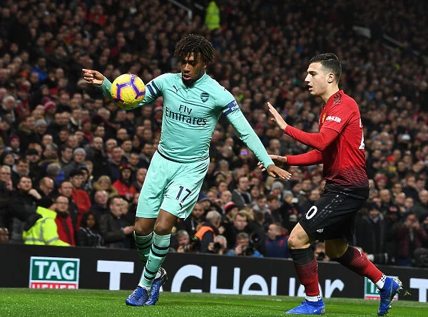 Arsenal's Alex Iwobi Clashes with Manchester United's Matteo Darmian in Premier League Showdown
