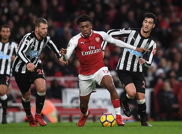 Arsenal's Alex Iwobi Clashes with Newcastle's Merino and Lejeune during Premier League Match