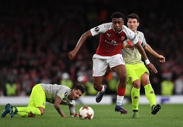 Arsenal's Alex Iwobi Faces Off Against FC Köln's Leonardo Bittencourt and Milos Jojic in Europa League Clash
