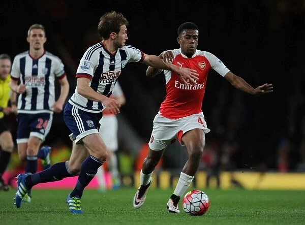 Arsenal's Alex Iwobi Faces Off Against Gareth McAuley in Intense Premier League Clash