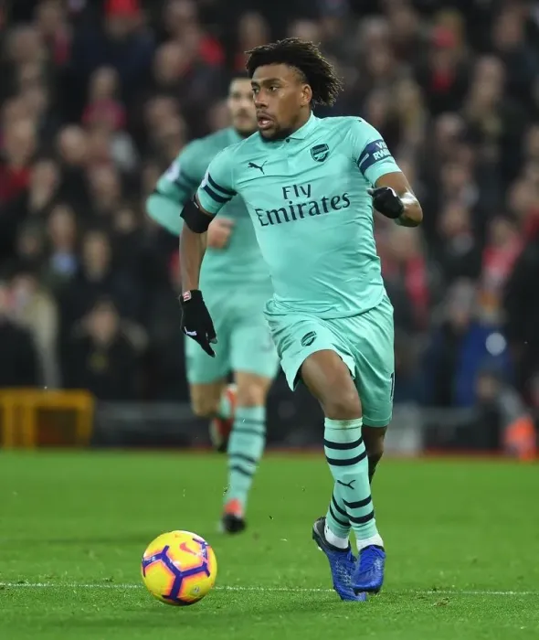 Framed Print : Arsenal's Alex Iwobi Faces Off Against Liverpool in Premier League Clash Framed Print : Arsenal's Alex Iwobi Faces Off Against Liverpool in Premier League Clash