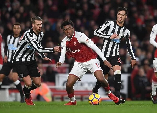 Arsenal's Alex Iwobi Faces Off Against Newcastle's Mikel Merino and Florian Lejeune