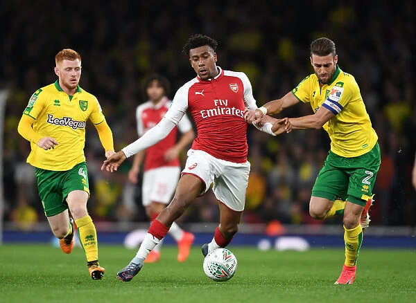 Arsenal's Alex Iwobi Faces Off Against Norwich's Ivo Pinto in Carabao Cup Clash