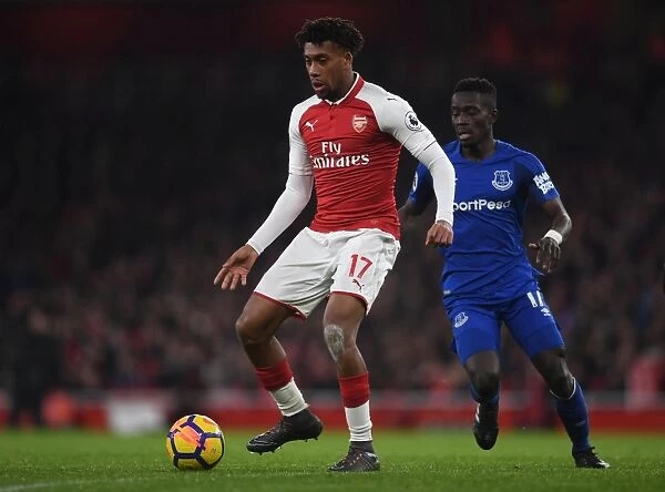 Arsenal's Alex Iwobi Fends Off Everton's Idrissa Gueye in Intense Premier League Clash