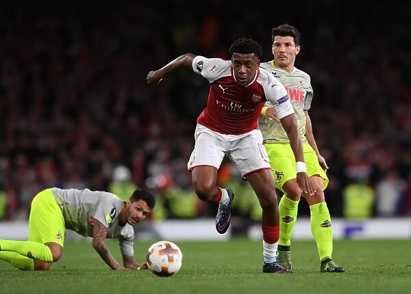 Arsenal's Alex Iwobi Goes Head-to-Head with FC Köln's Leonardo Bittencourt and Milos Jojic in Europa League Showdown
