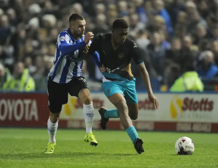 Framed Print : Arsenal's Alex Iwobi Goes Head-to-Head with Sheffield Wednesday's Jack Hunt in Capital One Cup Clash