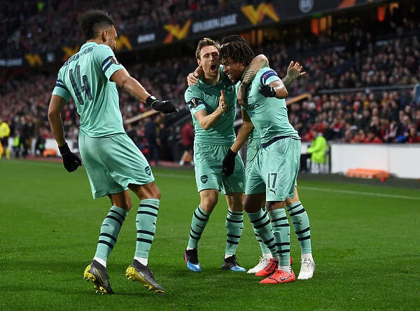Arsenal's Alex Iwobi, Monreal, and Aubameyang Celebrate Goal vs Stade Rennais in Europa League