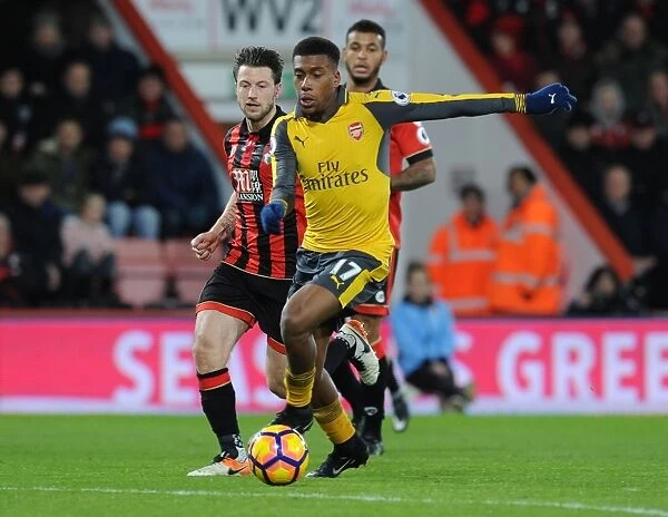 Arsenal's Alex Iwobi Outmaneuvers Bournemouth's Harry Arter in Premier League Clash
